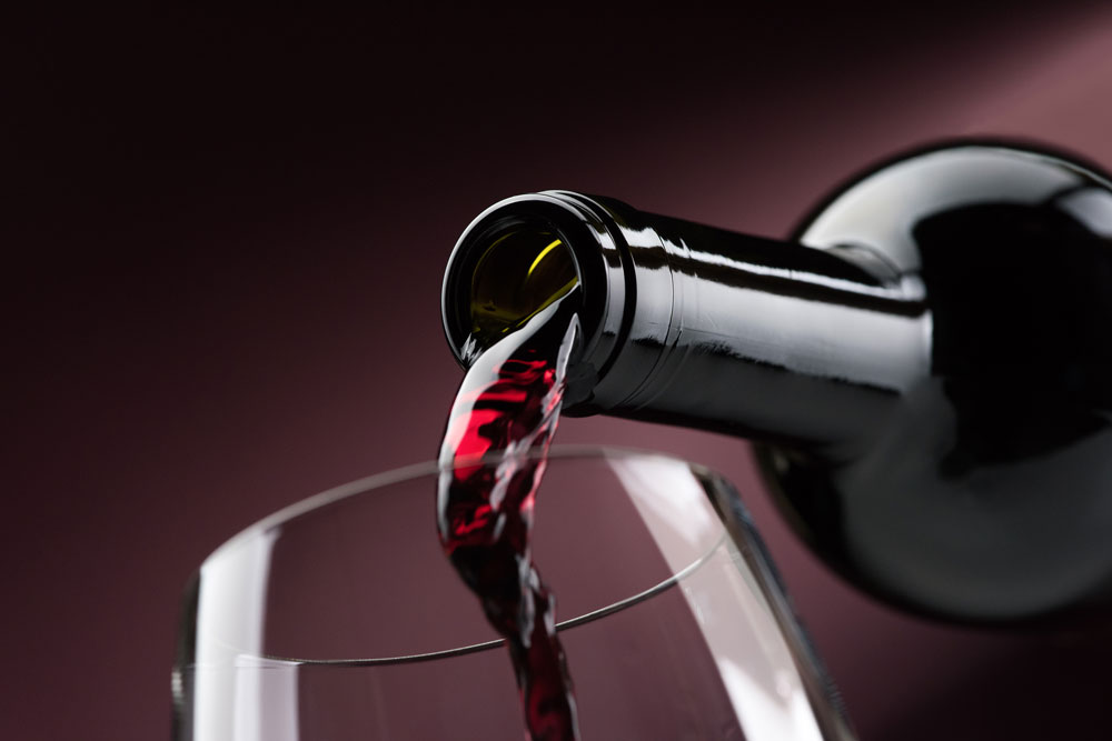 pouring-red-wine-into-a-wineglass-P9QEG34
